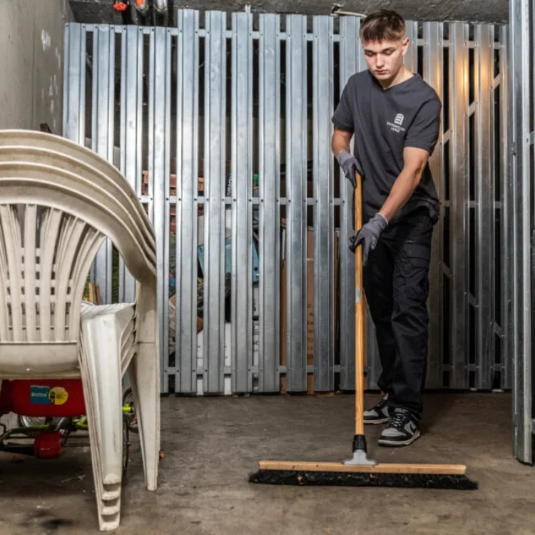 Grundreinigung Köln - Mitarbeiter fegt den Boden sauber